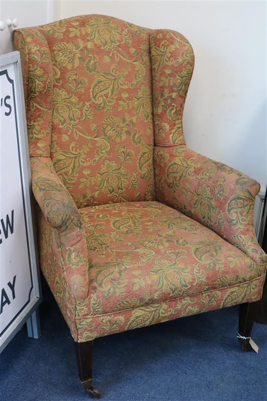 An Edwardian mahogany wing armchair